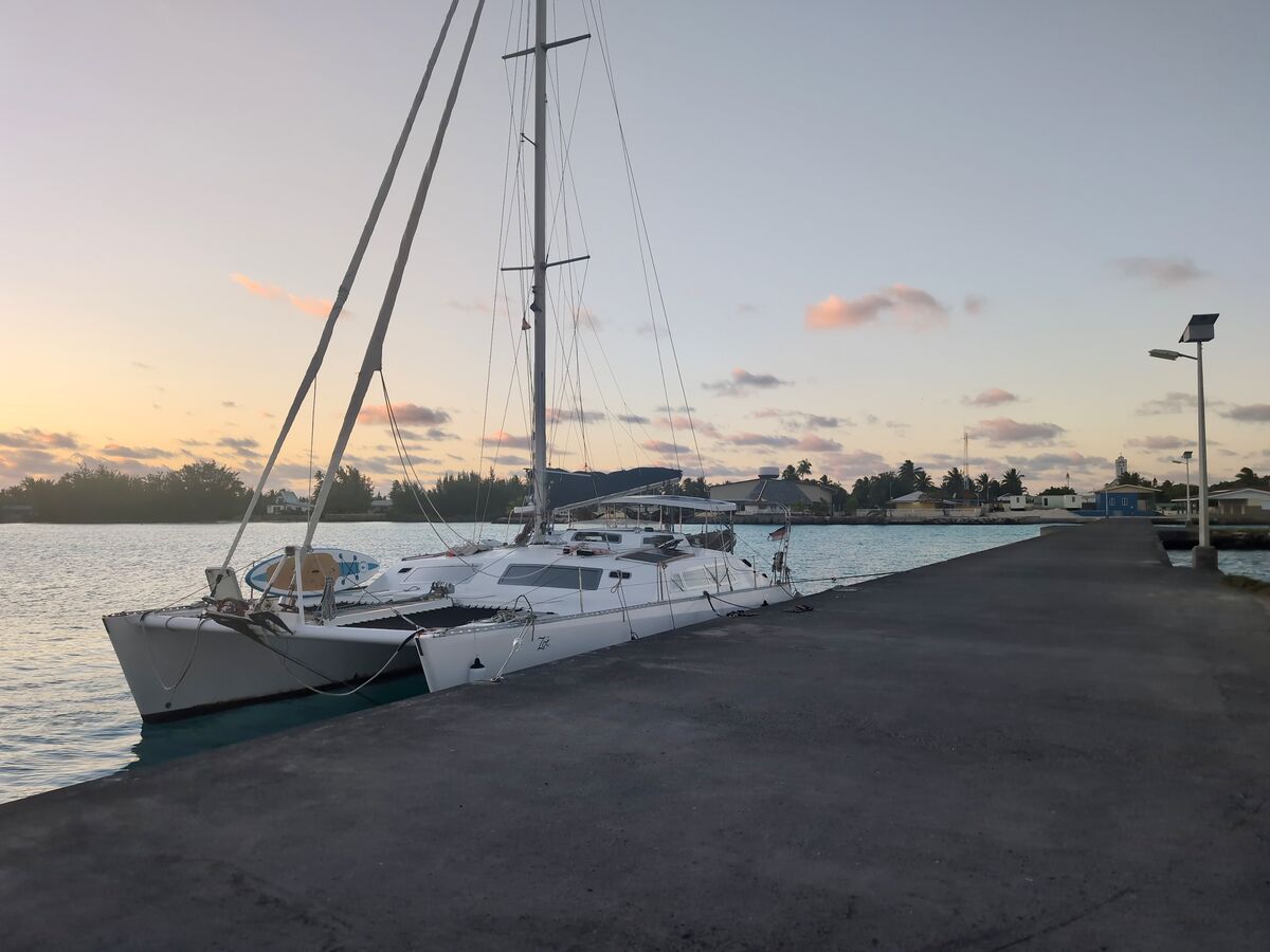 Zoë alongside a quay at sunset in the Tuamotus