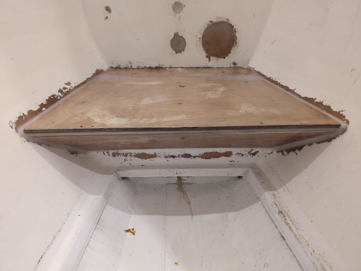 The new plywood base for the washing machine epoxied in place